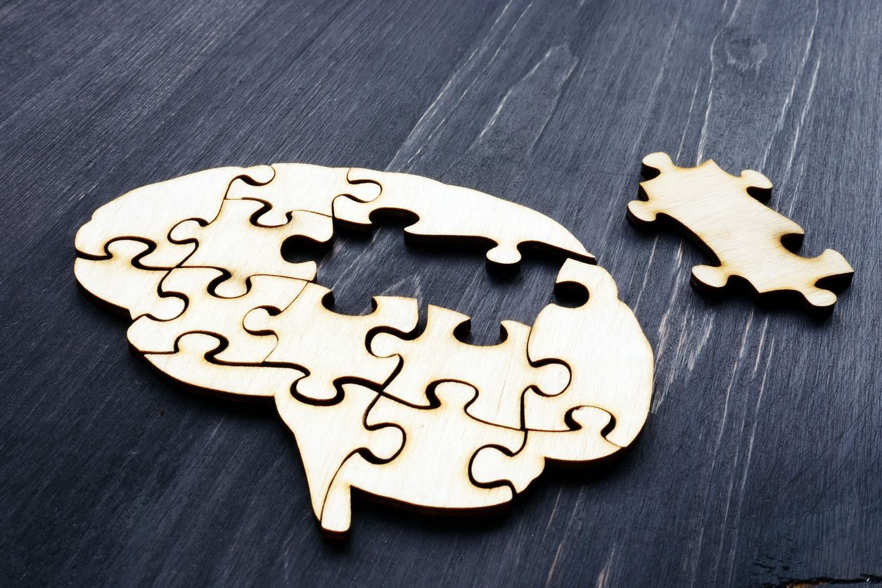 a puzzle in the shape of a brain with a missing piece