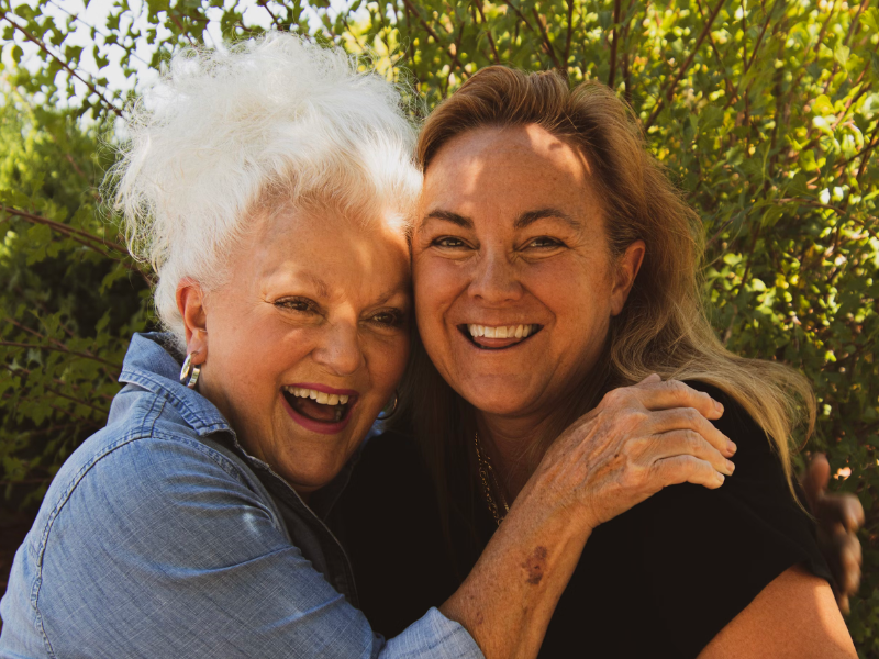 senior aged woman laughing with another woman