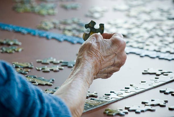 senior using puzzle game to improve memory