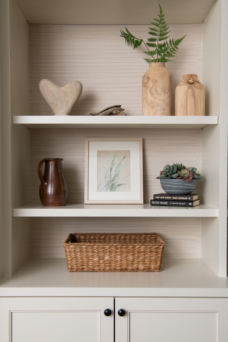 A bookshelf with a basket , vases , and a picture on it - Charlotte, NC