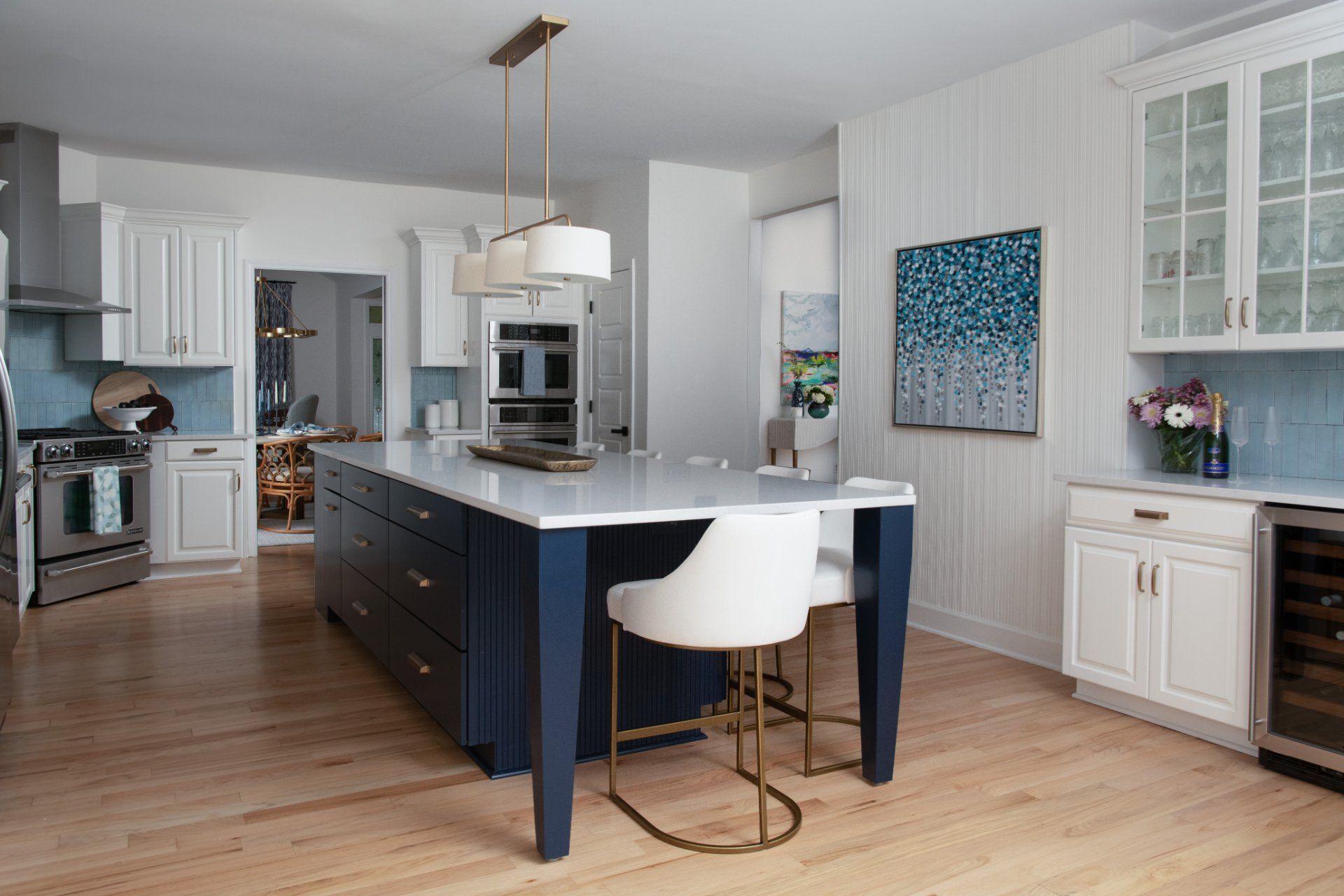 Modern kitchen with a blue island, white cabinets, and wooden floors | Charlotte, NC | An Inspiring Home