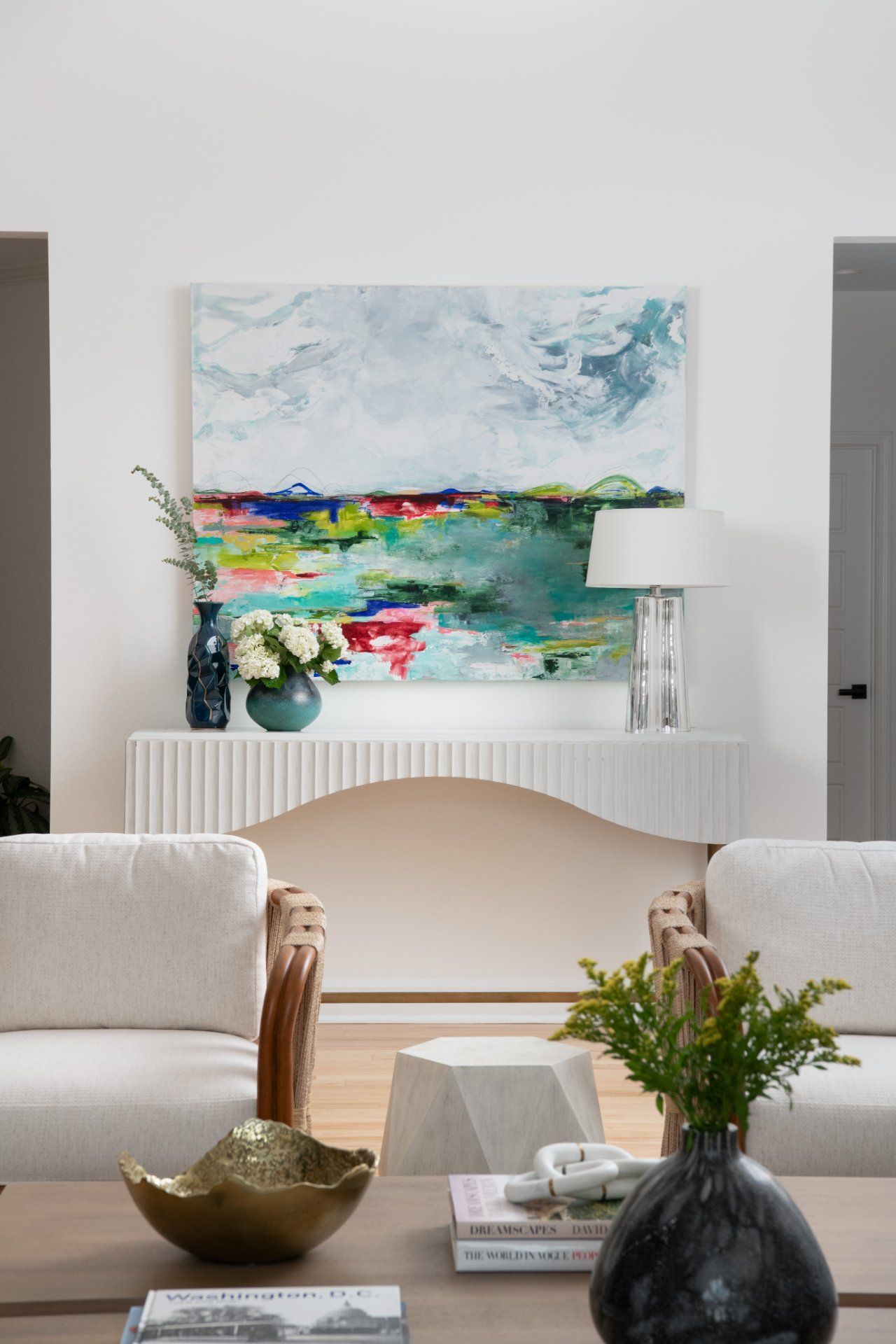 Living room with abstract art, white console table, two armchairs, and a coffee table | Charlotte, NC | An Inspiring Home