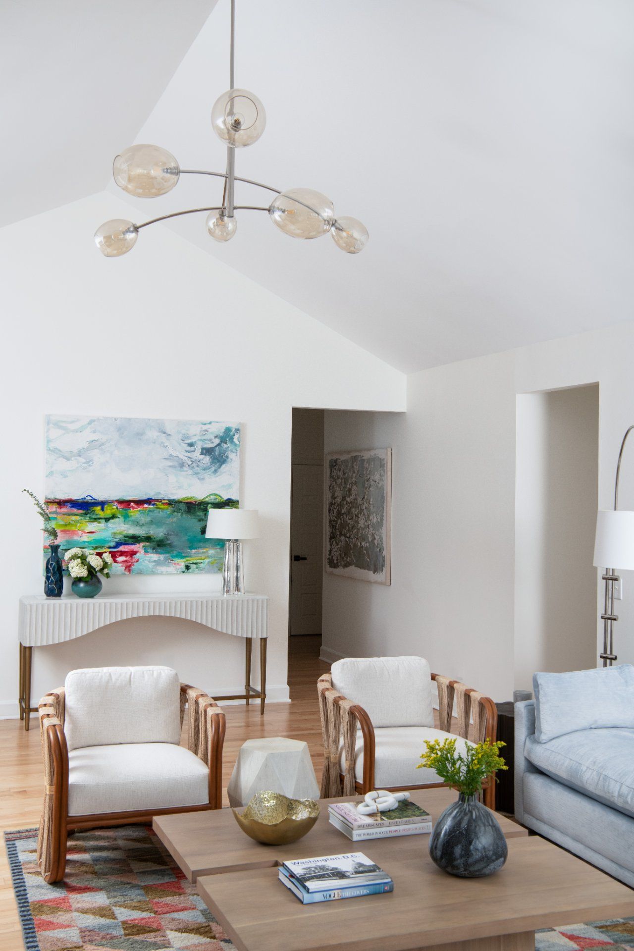 Living room with white walls, wood floors, modern furniture, and abstract art | Charlotte, NC | An Inspiring Home