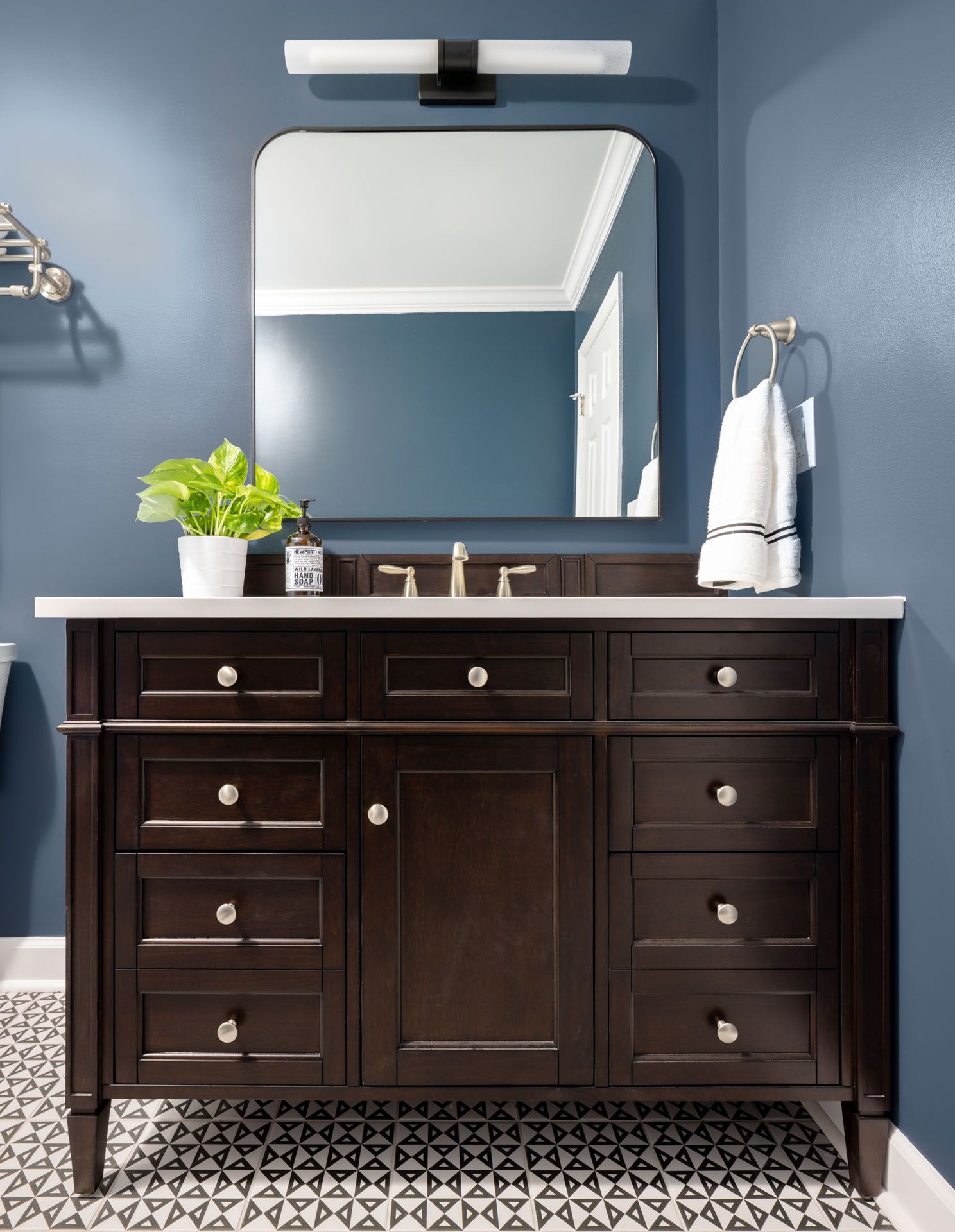 A bathroom with a vanity and a mirror