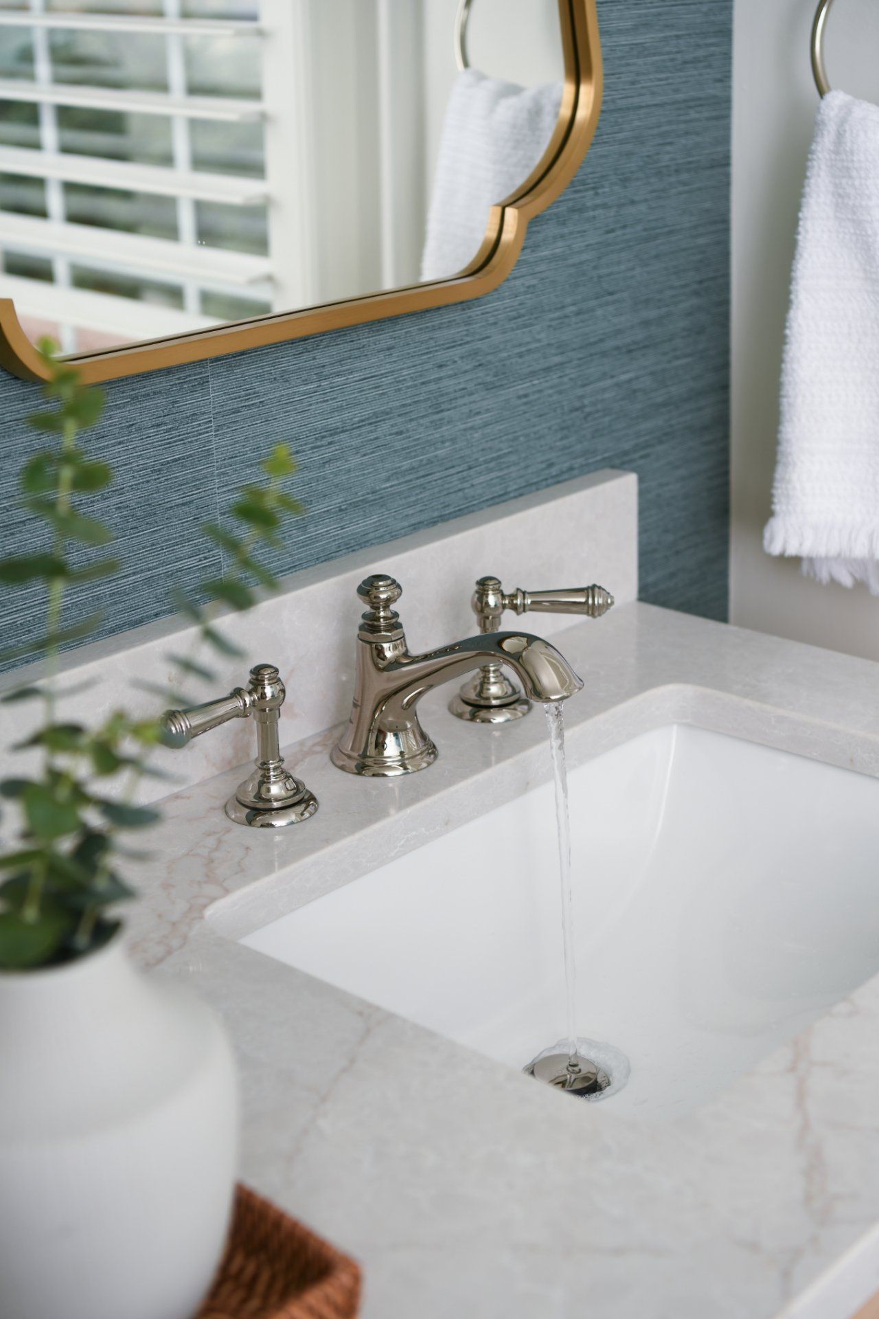Elegant bathroom sink with chrome faucet, white marble countertop, and gold-framed mirror | Weddington, NC | An Inspiring Home