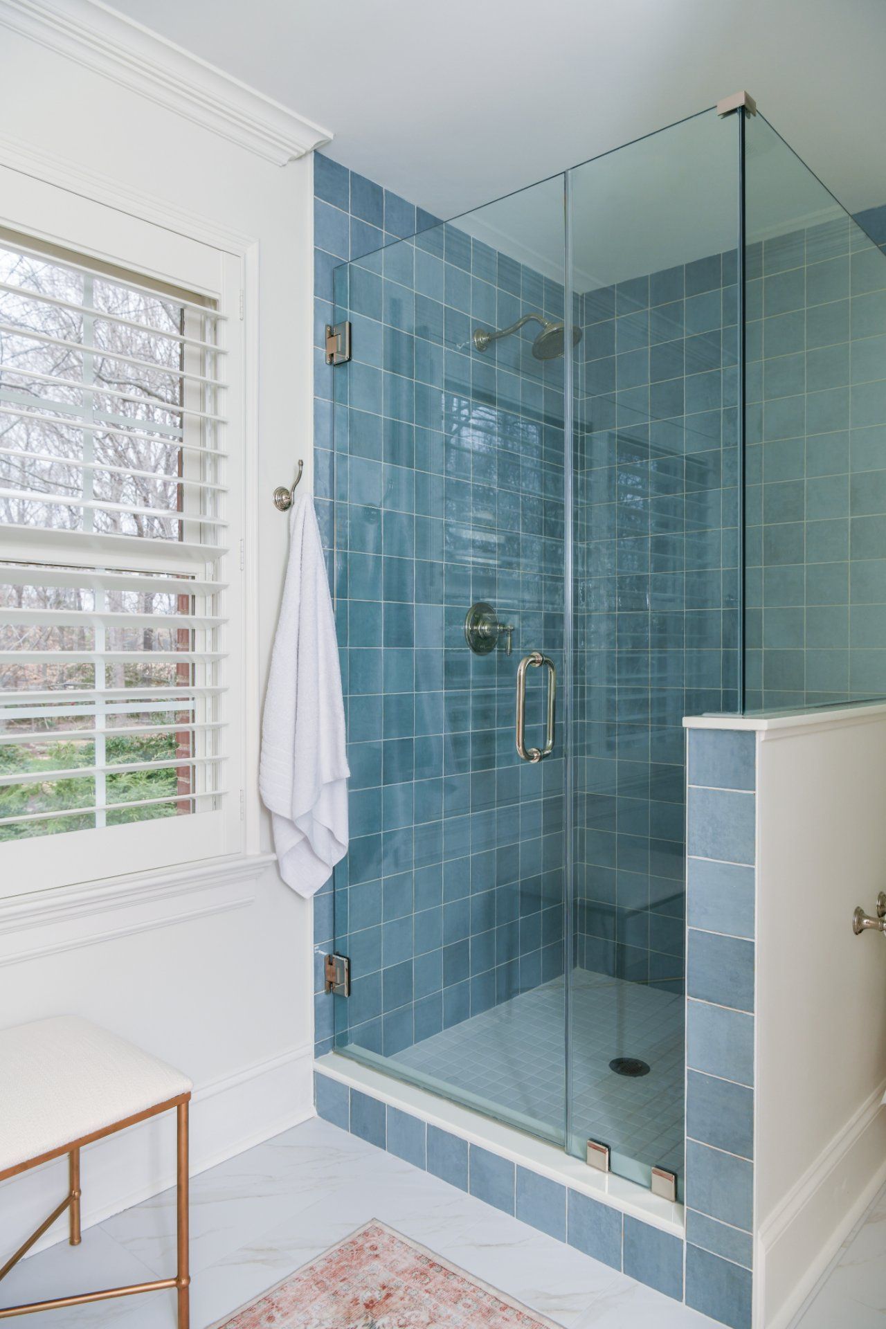 Modern bathroom with blue-tiled glass shower enclosure and white window blinds | Weddington, NC | An Inspiring Home