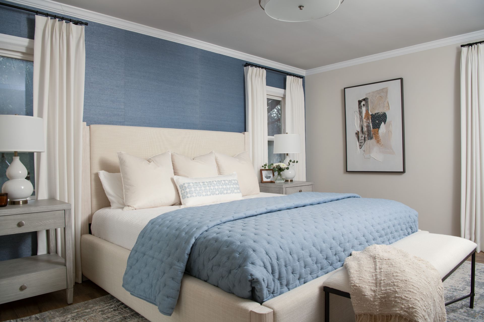 Bedroom with blue accent wall, white bedding, nightstands, artwork, and curtains | Charlotte, NC | An Inspiring Home