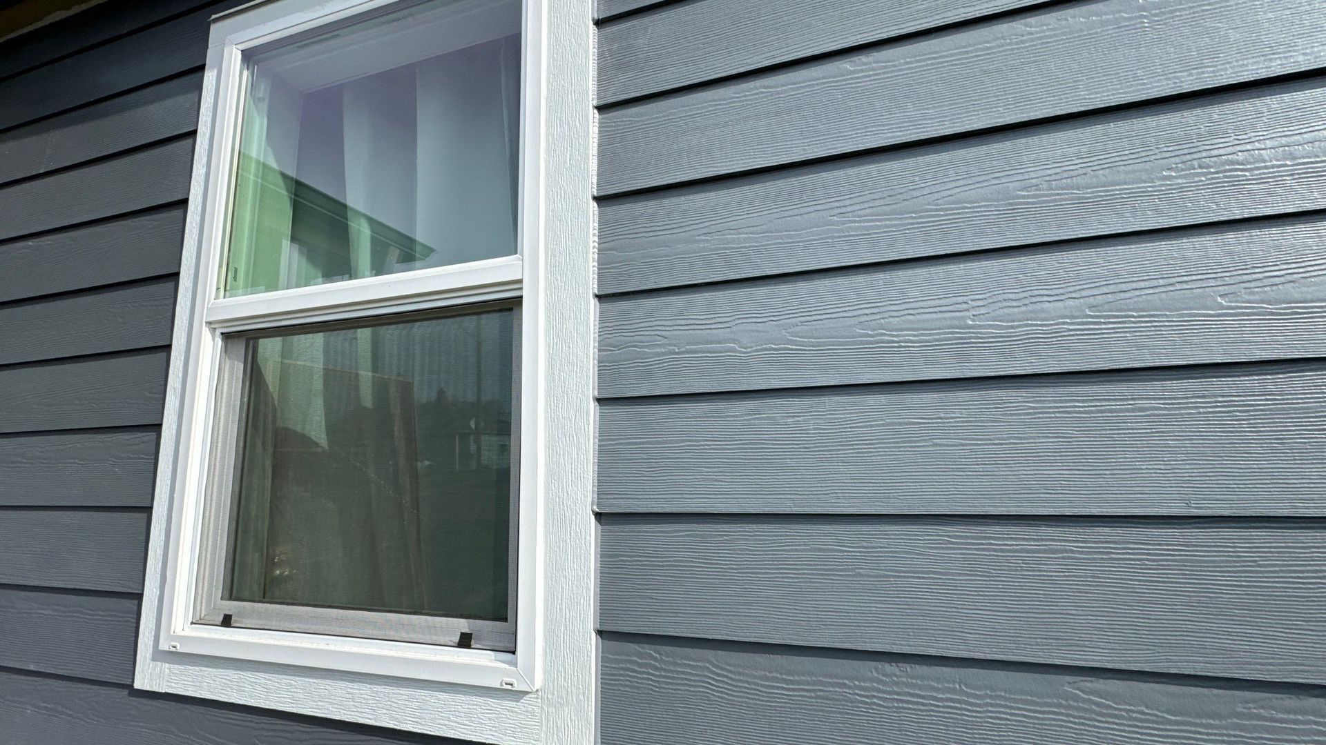 Close-up of weather-resistant vinyl siding on a house in Eugene, Oregon.