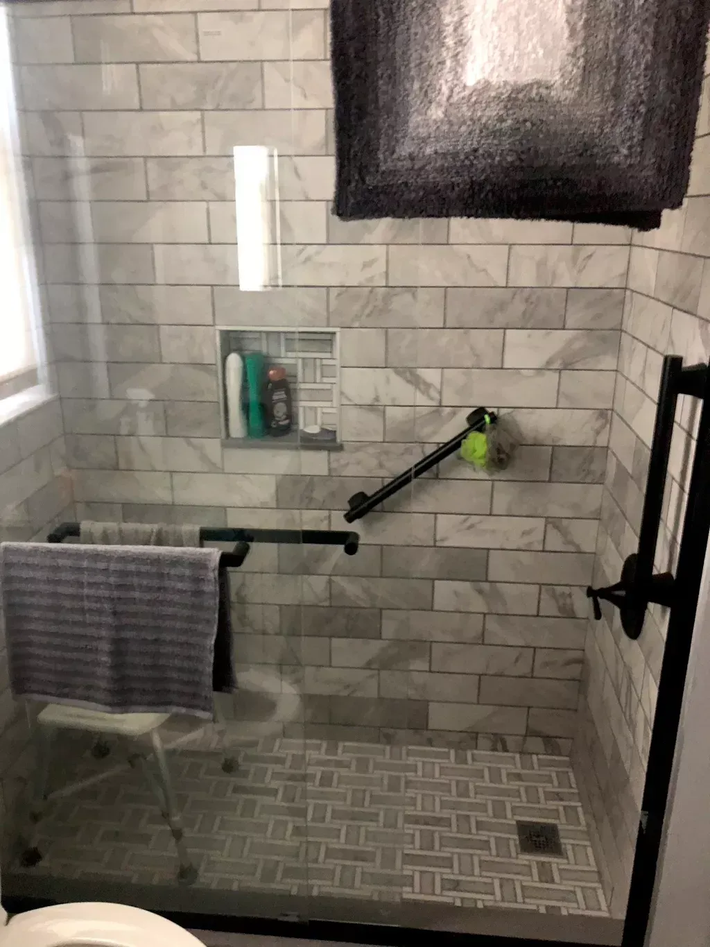 A bathroom with a walk in shower and a toilet.