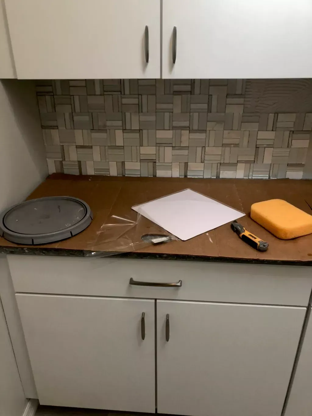 A kitchen counter with a piece of paper on it