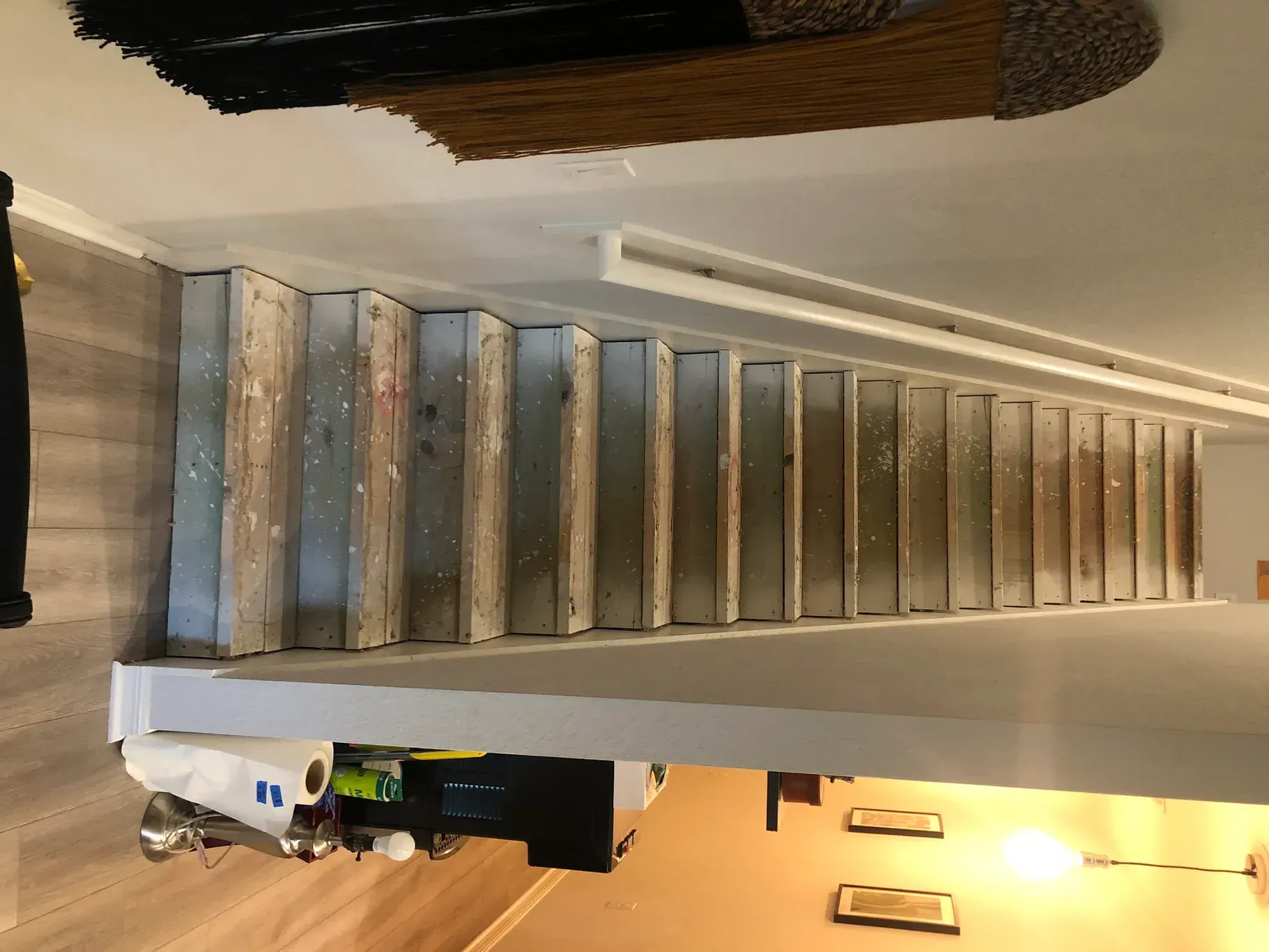 A wooden staircase is being built in a house.