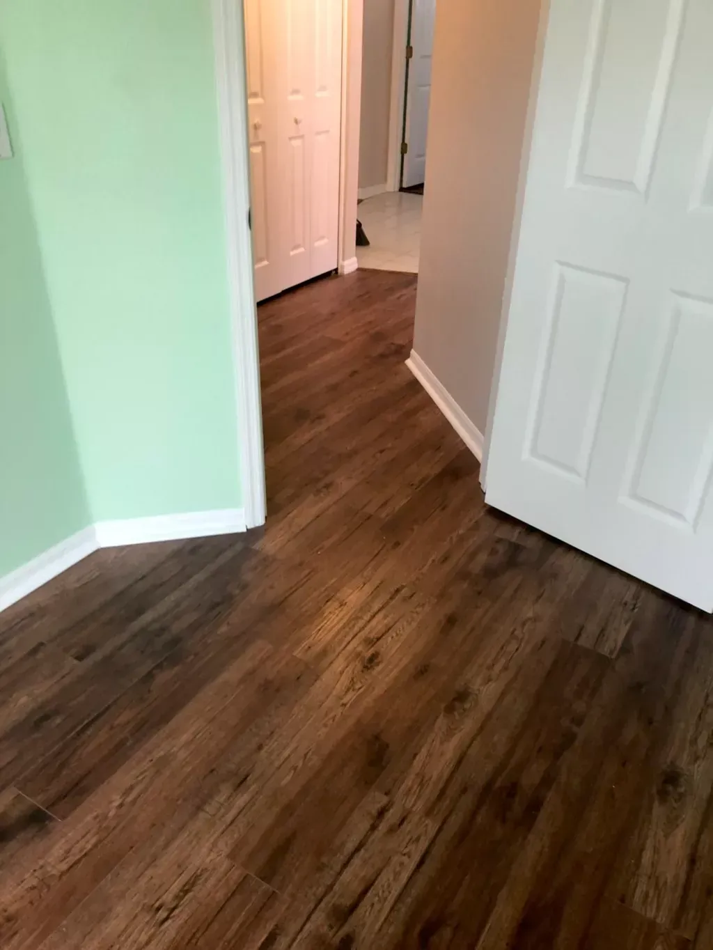A room with hardwood floors and green walls.