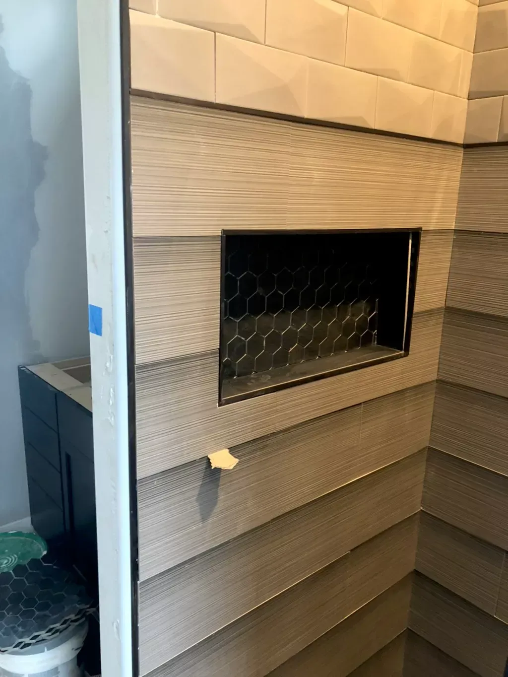 A bathroom with a niche in the wall and a toilet.