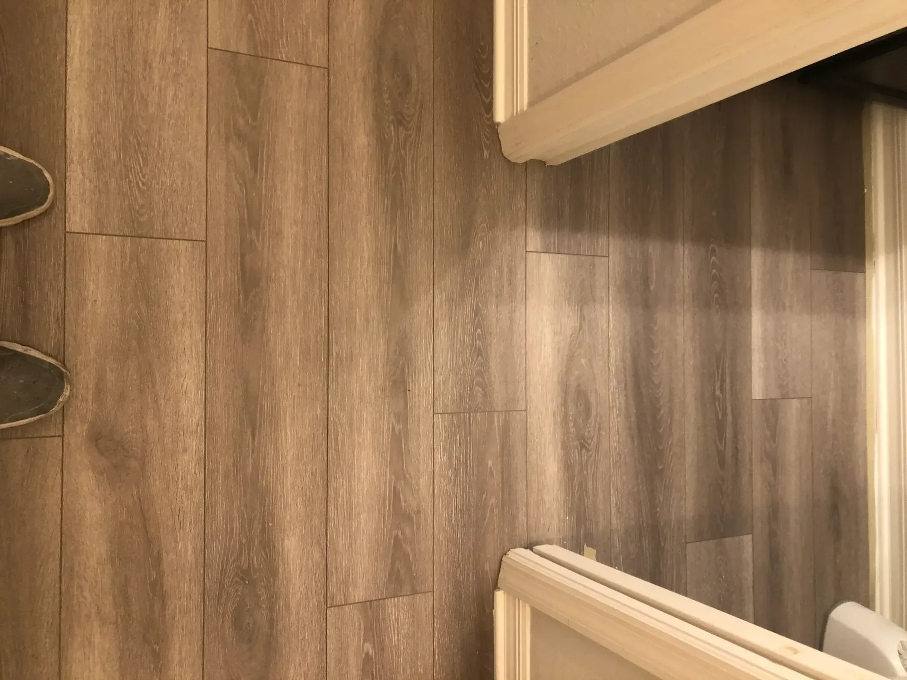 A bathroom with a wooden floor and a toilet.