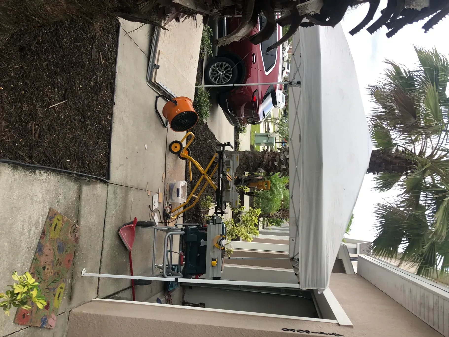 A red truck is parked on the side of the road.