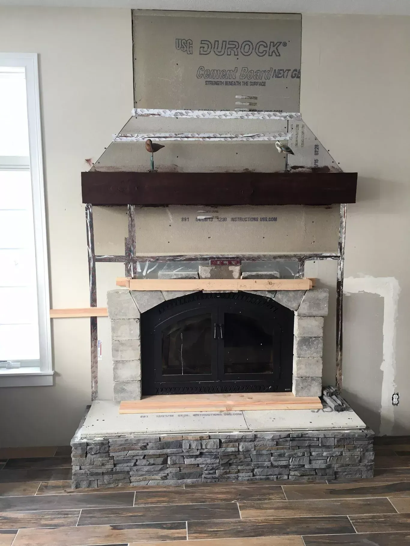 A fireplace is being built in a living room