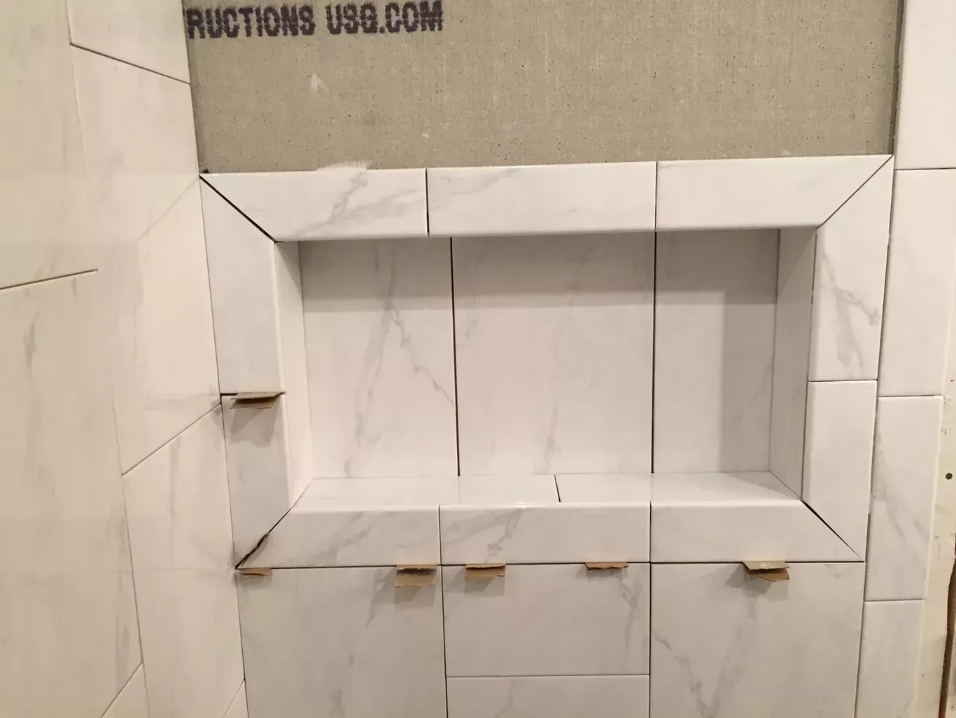A shower niche is being built in a bathroom.