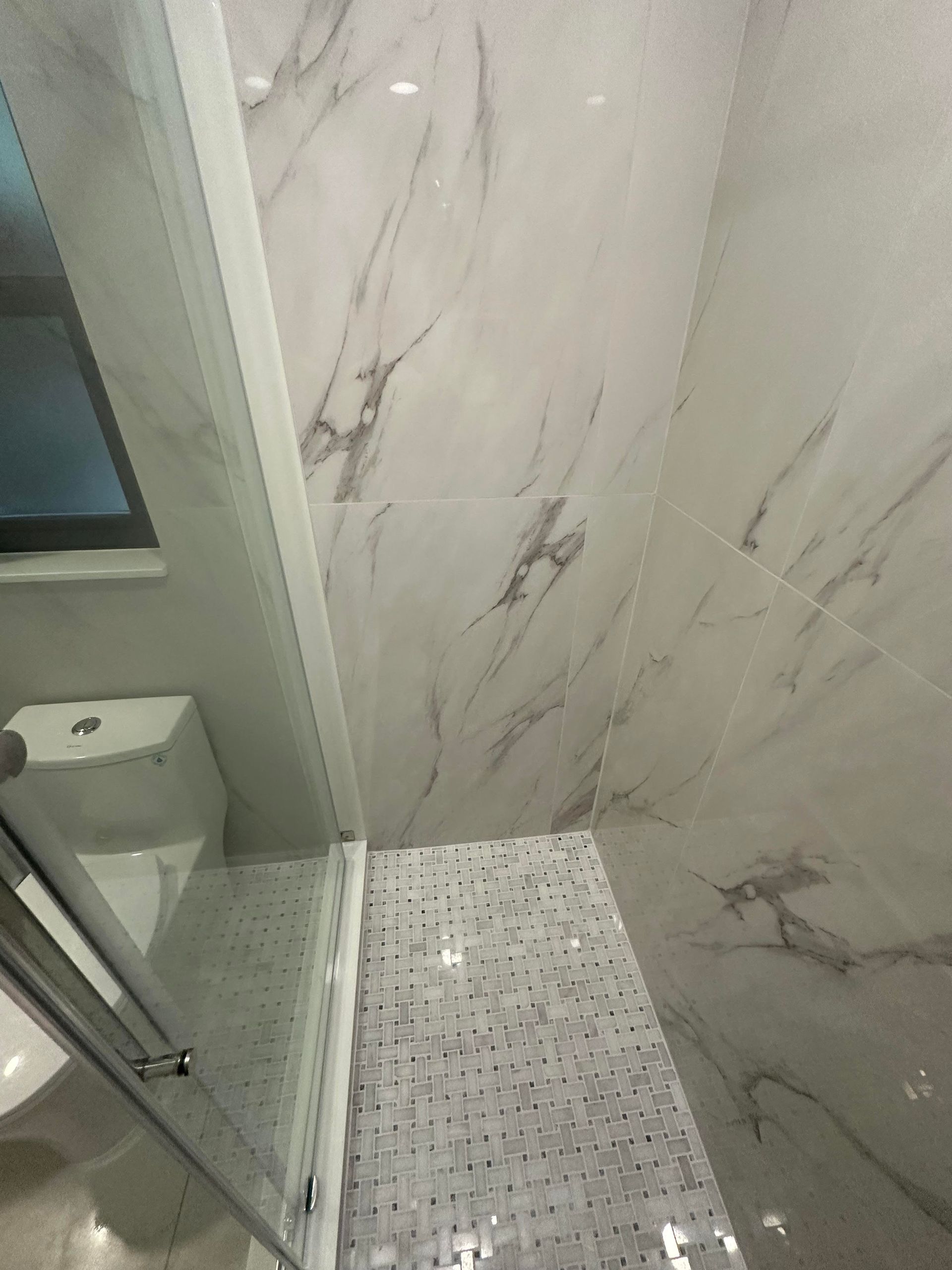 A staircase with a white railing and a wooden handrail