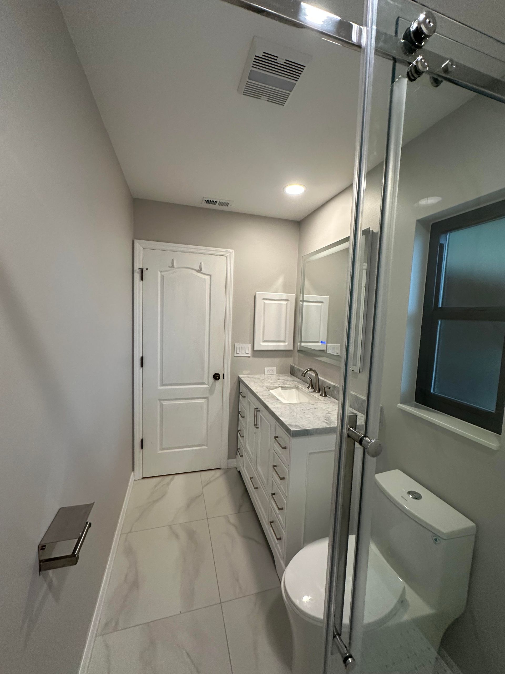 A kitchen with a wooden floor and white cabinets