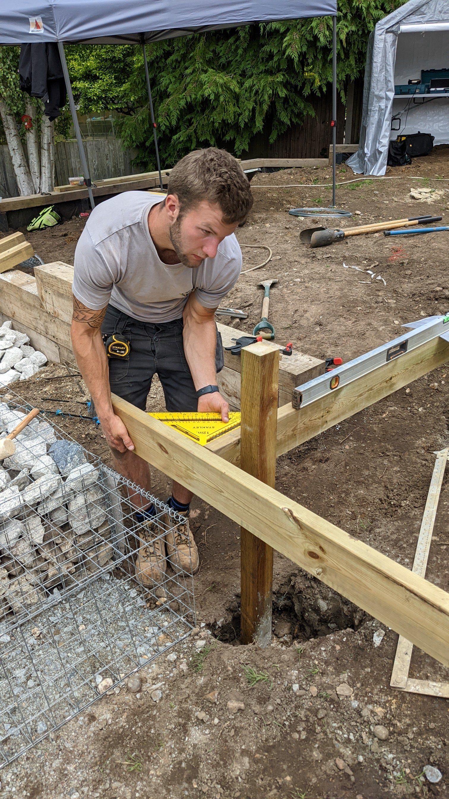 Landscaper building decking in garden