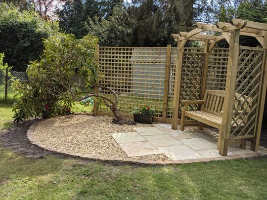 Garden with small patio and garden bench