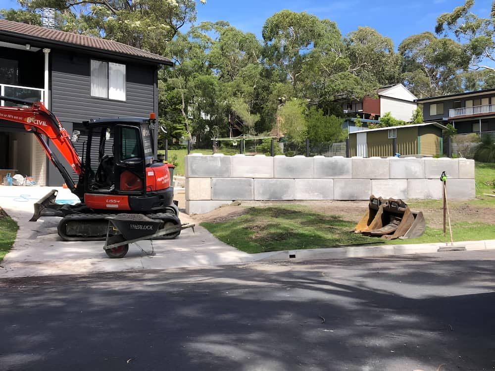 A Red Excavator is Parked in Front of a House — BeCivil in Tomerong, NSW