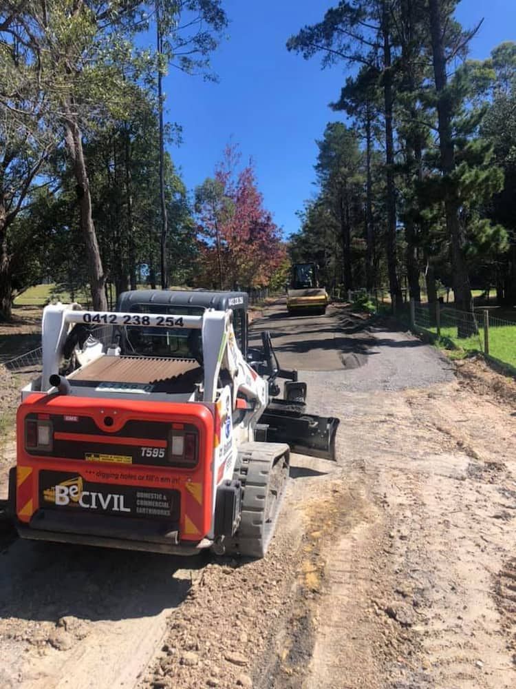 A Bulldozer is Driving Down a Dirt Road — BeCivil in Tomerong, NSW