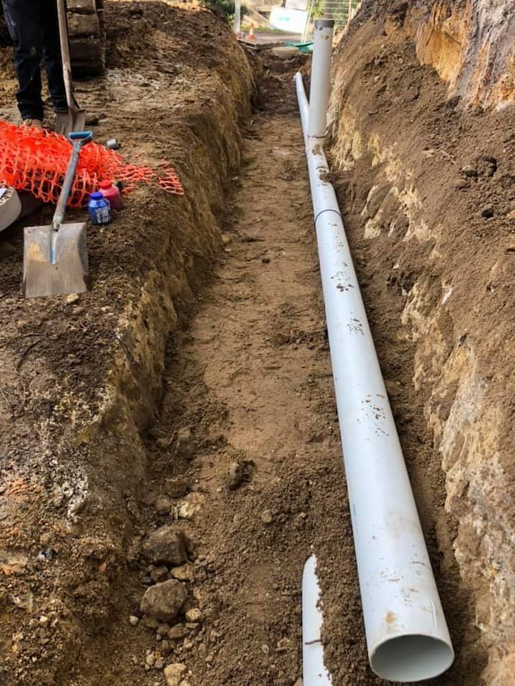 A Large White Pipe is Being Installed in a Trench — BeCivil in Nowra, NSW