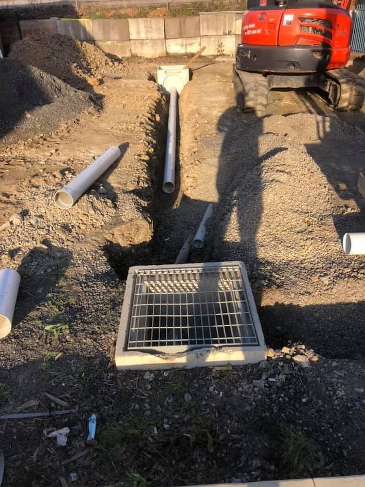 A Manhole Cover is Being Installed in a Hole in the Ground — BeCivil in Tomerong, NSW