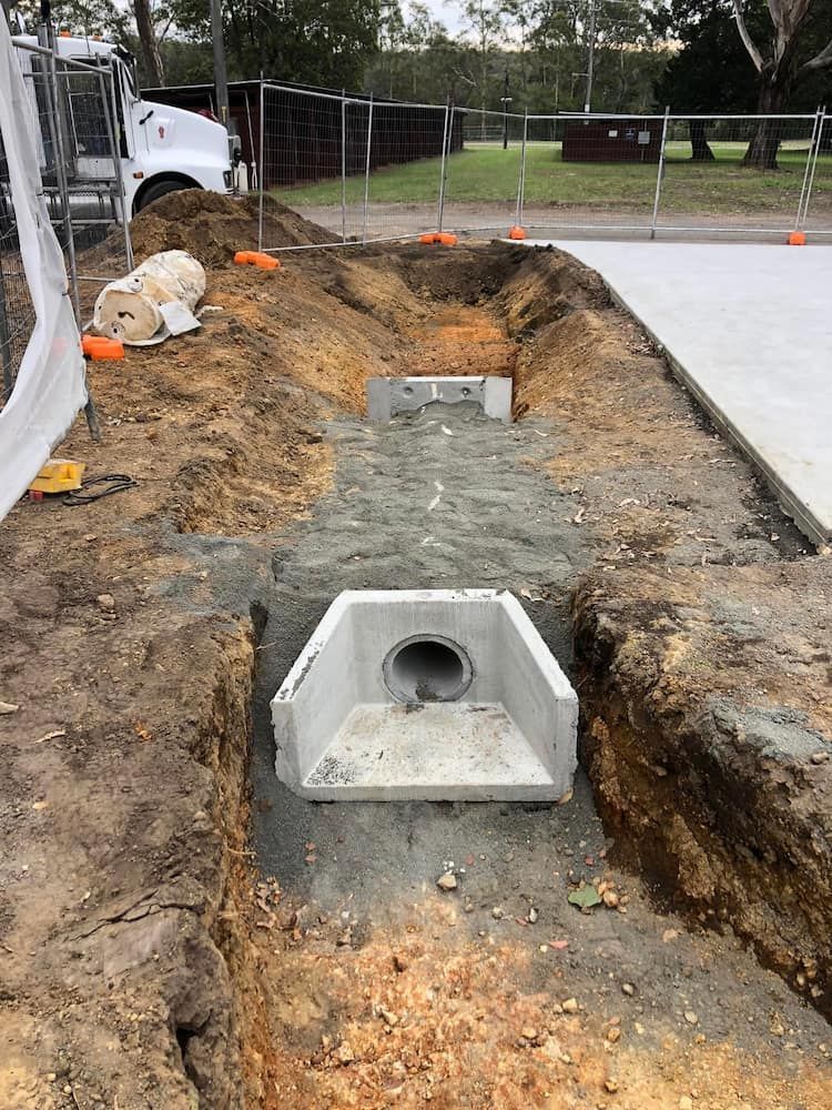 A Concrete Pipe is Being Installed in a Hole in the Ground — BeCivil in Vincentia, NSW