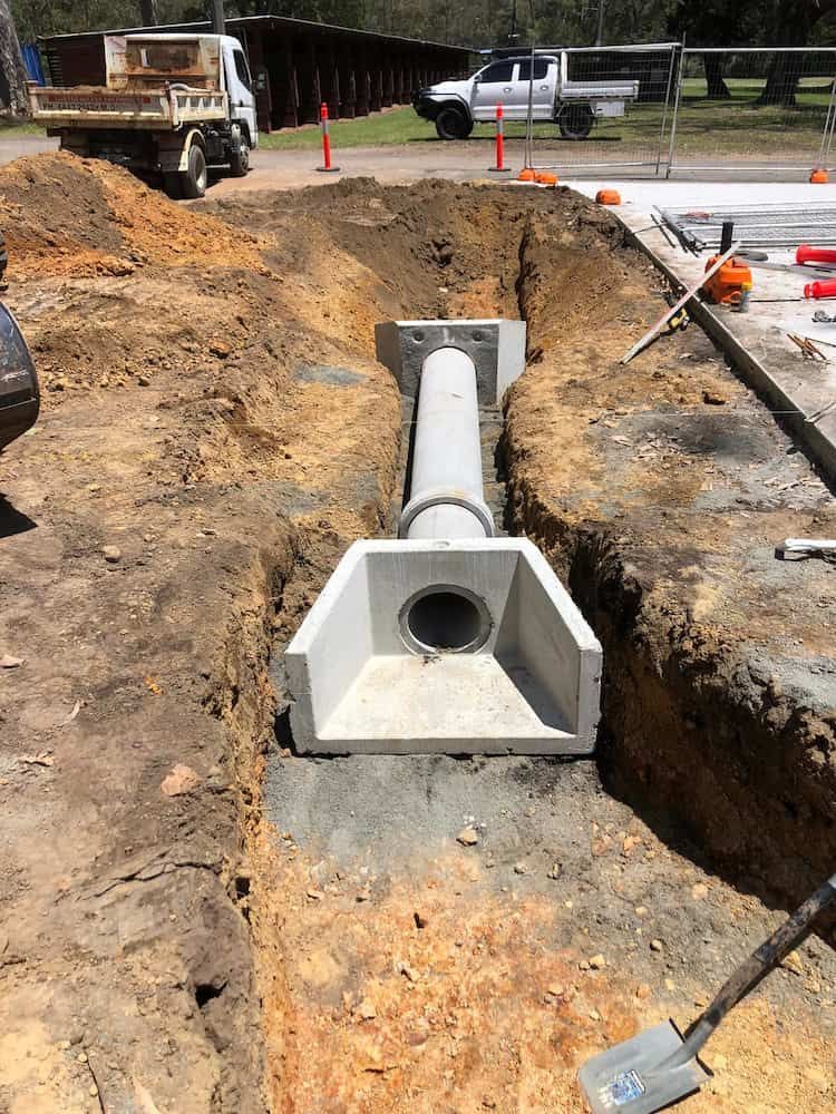 A Concrete Pipe is Being Installed in a Hole in the Ground — BeCivil in Jervis Bay, NSW