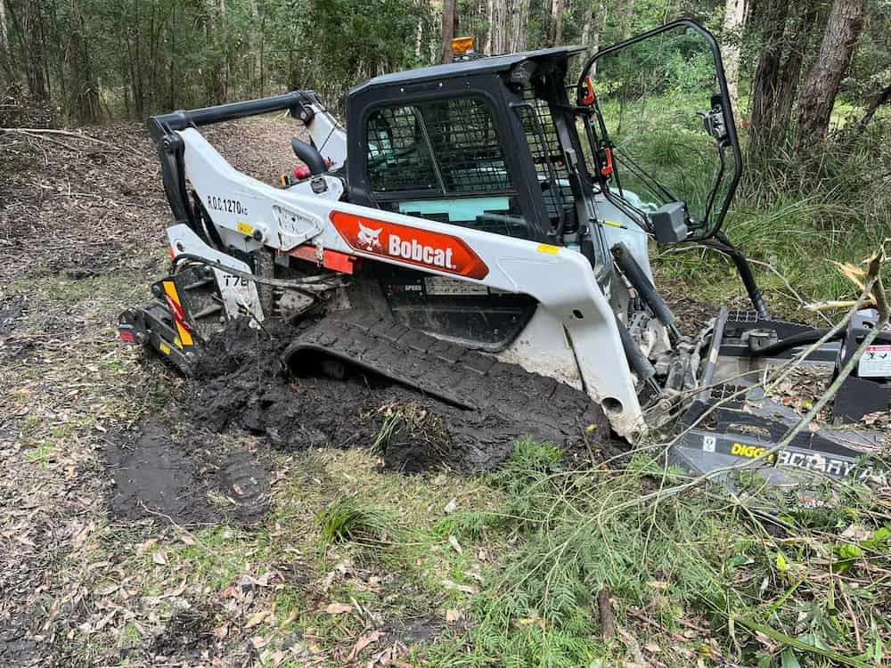 A Bobcat Bulldozer is Stuck in the Mud in the Woods — BeCivil in Huskisson, NSW