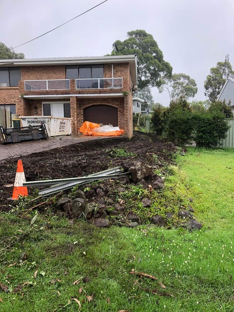 A Large Brick House With a Lot of Dirt in Front of It — BeCivil in Berry, NSW