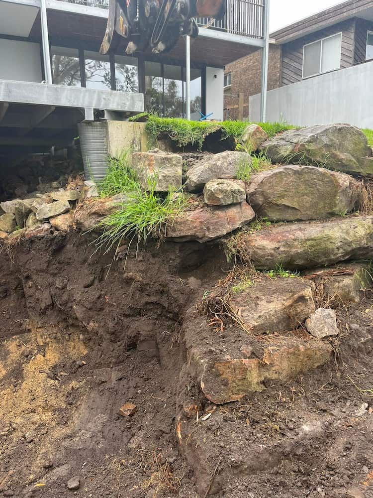 A Pile of Rocks Sitting on Top of a Dirt Hill Next to a House — BeCivil in Tomerong, NSW