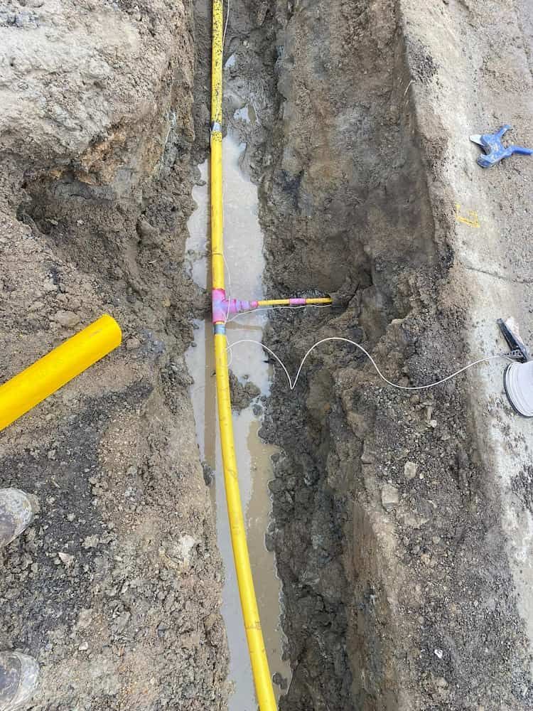 A Yellow Pipe is Laying in the Dirt in a Trench — BeCivil in Tomerong, NSW