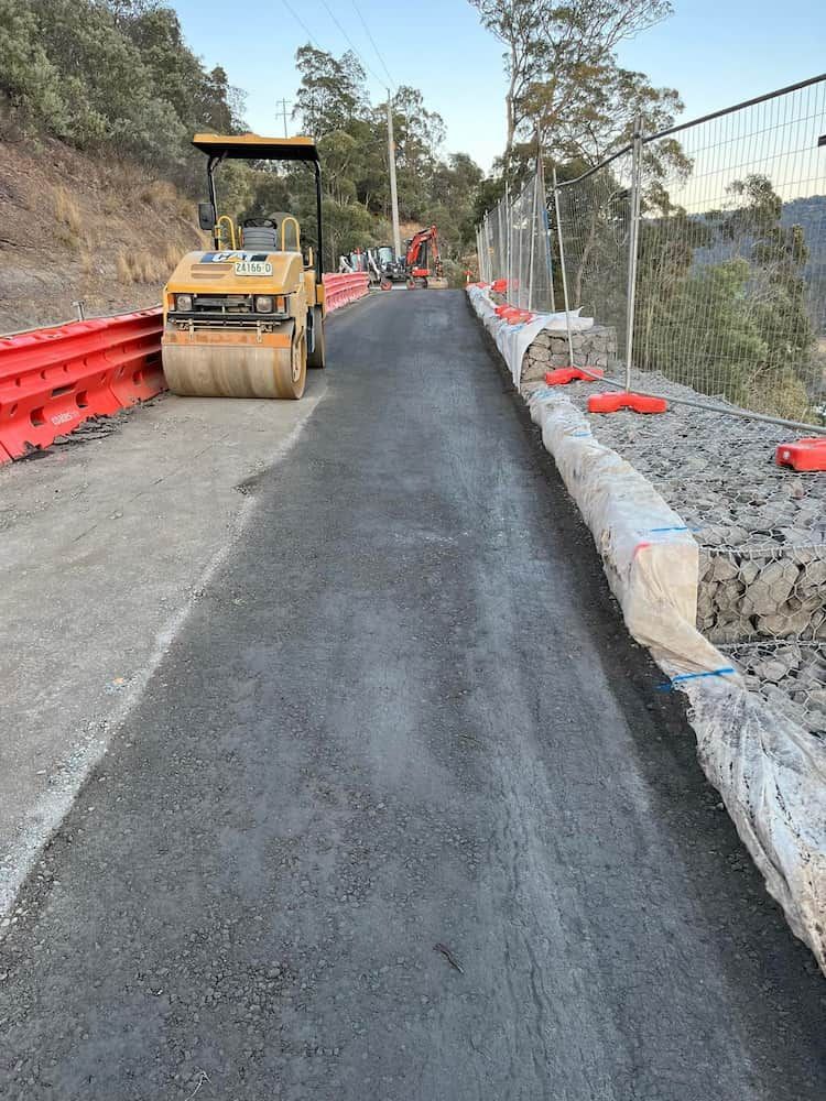 A Yellow Roller is Sitting on the Side of a Road — BeCivil in Tomerong, NSW
