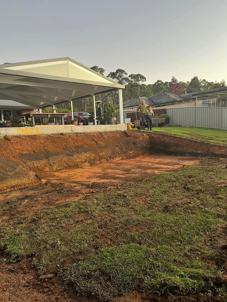 A Man is Digging a Hole in the Ground in Front of a House — BeCivil in Ulladulla, NSW