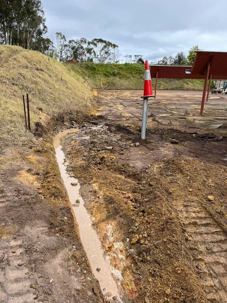 A Dirt Road With a Red and White Traffic Cone in the Middle of It — BeCivil in Huskisson, NSW
