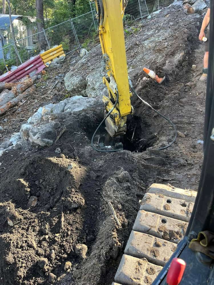 A Yellow Excavator is Digging a Hole in the Ground — BeCivil in Tomerong, NSW