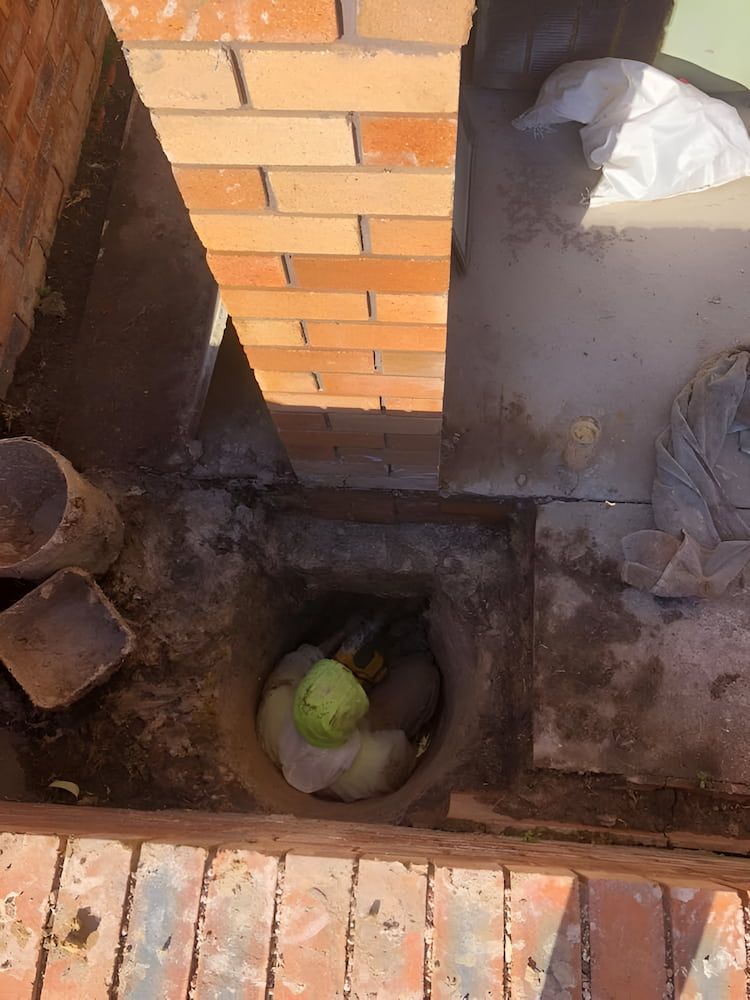 A Hole in the Ground Next to a Brick Wall With a Green Object in It — BeCivil in Tomerong, NSW
