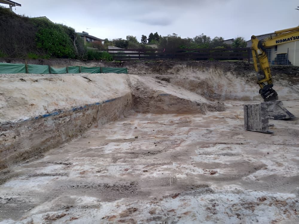 A Yellow Excavator is Digging a Hole in the Ground — BeCivil in Nowra, NSW