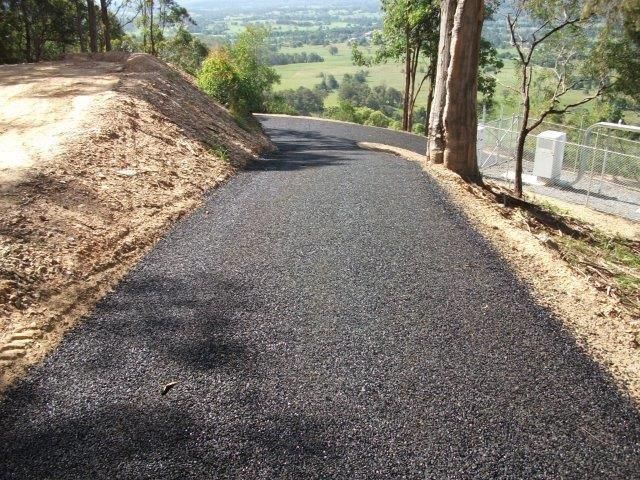 A Road That Is Going Up A Hill With Trees On The Side Of It — Blue Dog Landscape Supplies In Newee Creek, NSW
