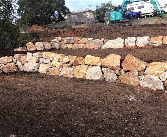 A Large Pile Of Rocks Is Sitting On Top Of A Dirt Field — Blue Dog Landscape Supplies In Newee Creek, NSW
