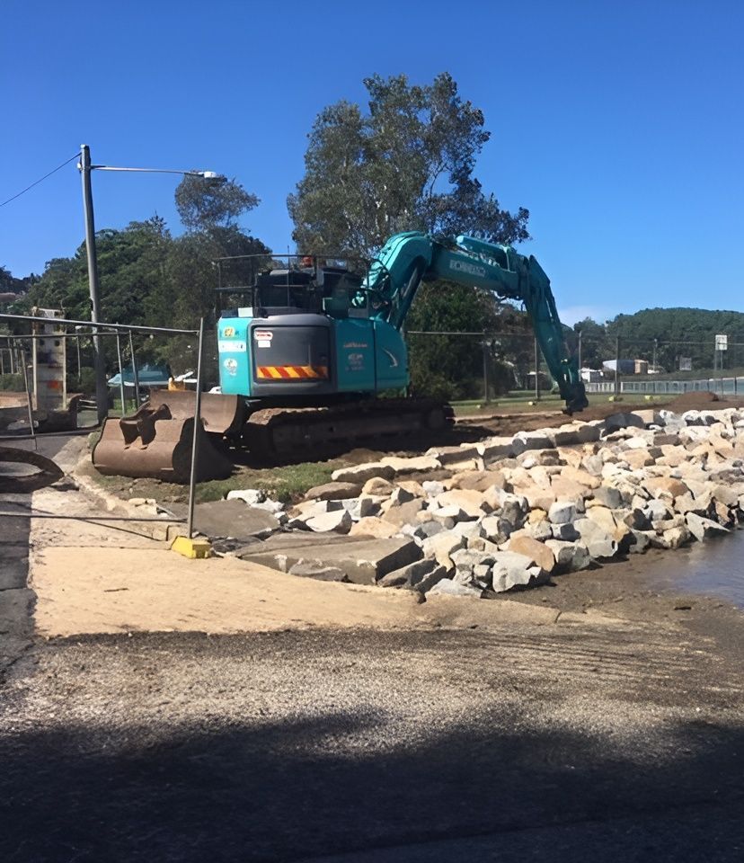 A Large Blue Excavator Is Working On A Construction Site — Blue Dog Landscape Supplies In Newee Creek, NSW