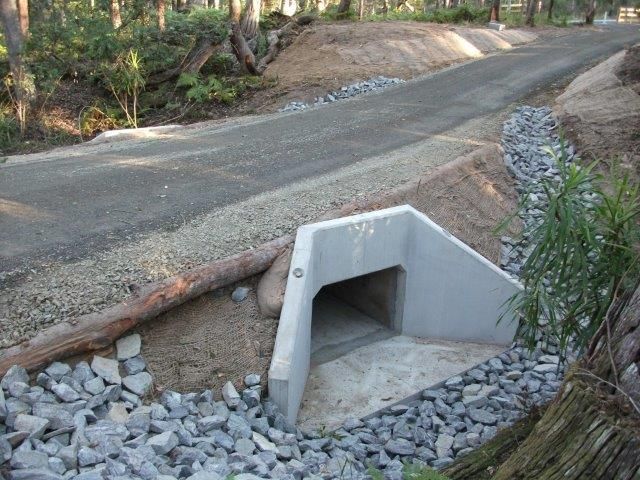 A road with a concrete tunnel in the middle of it
