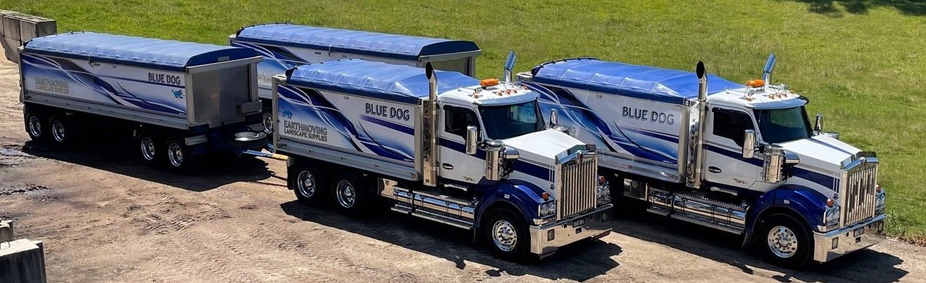 Three dump trucks are parked next to each other on a dirt road — Blue Dog Landscape Supplies In Newee Creek, NSW