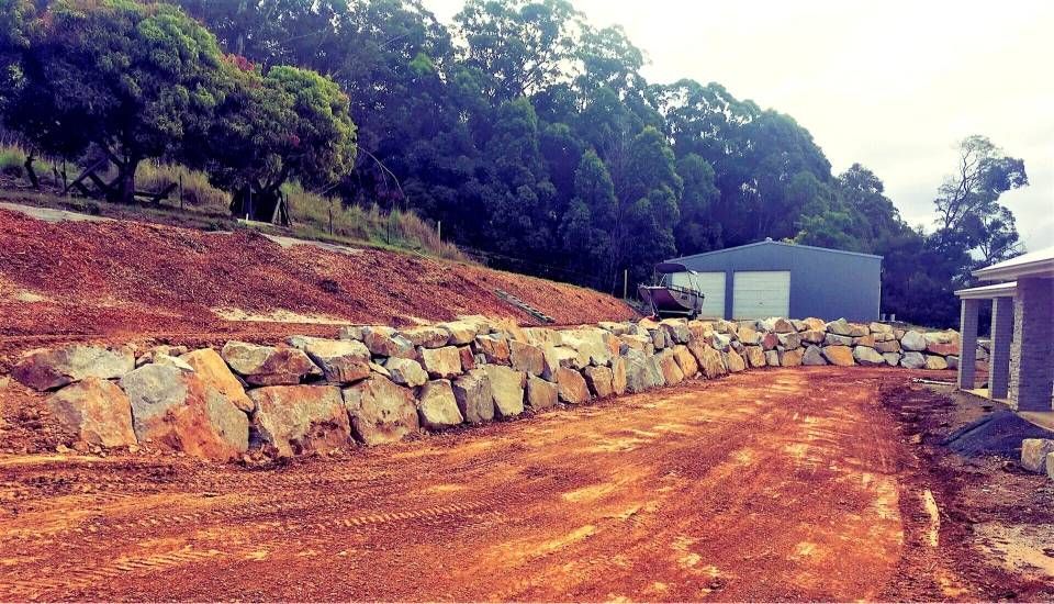 A Large Pile Of Rocks Is Sitting On Top Of A Dirt Hill — Blue Dog Landscape Supplies In Newee Creek, NSW