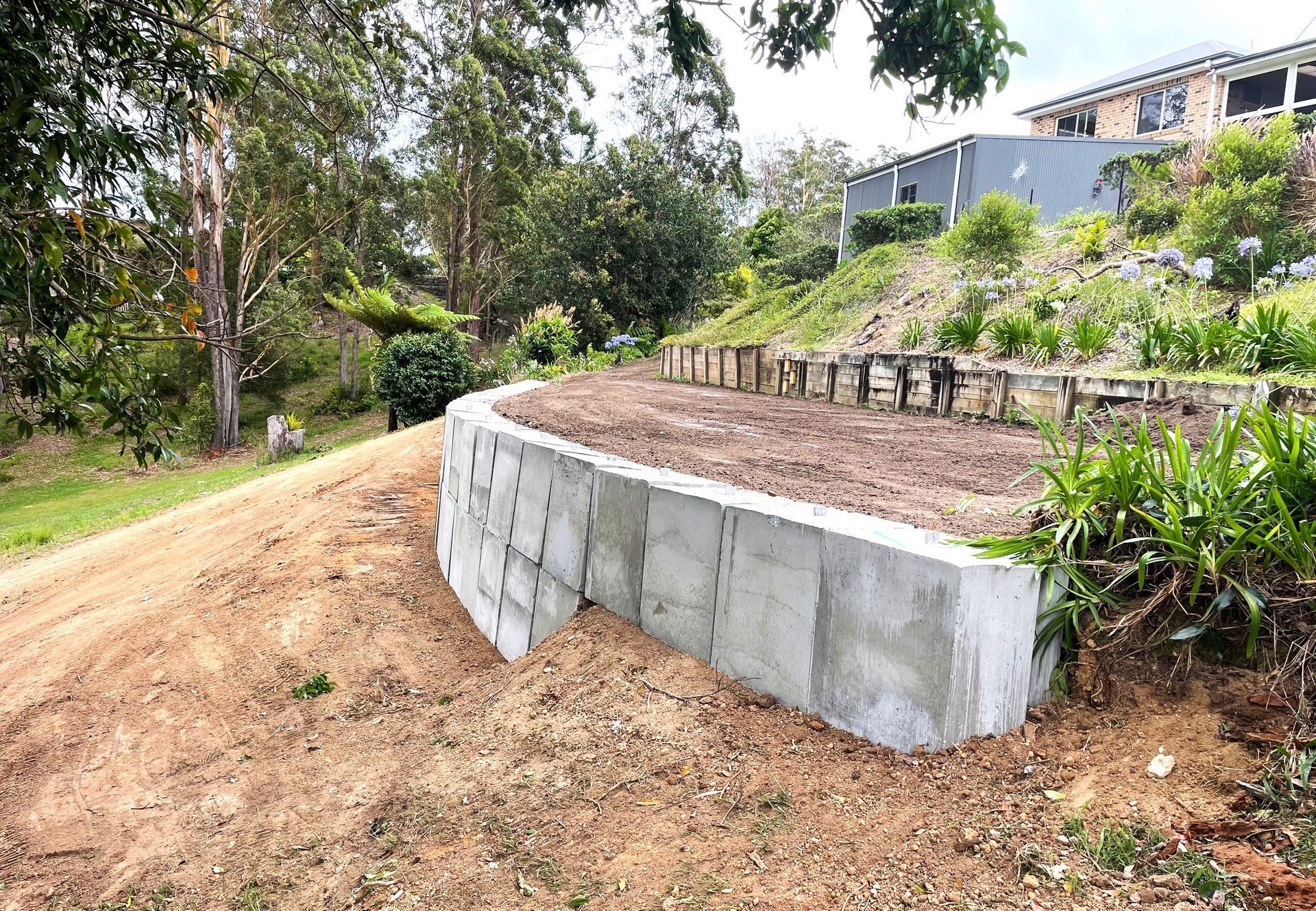 A concrete wall is sitting on the side of a dirt road — Blue Dog Landscape Supplies In Newee Creek, NSW