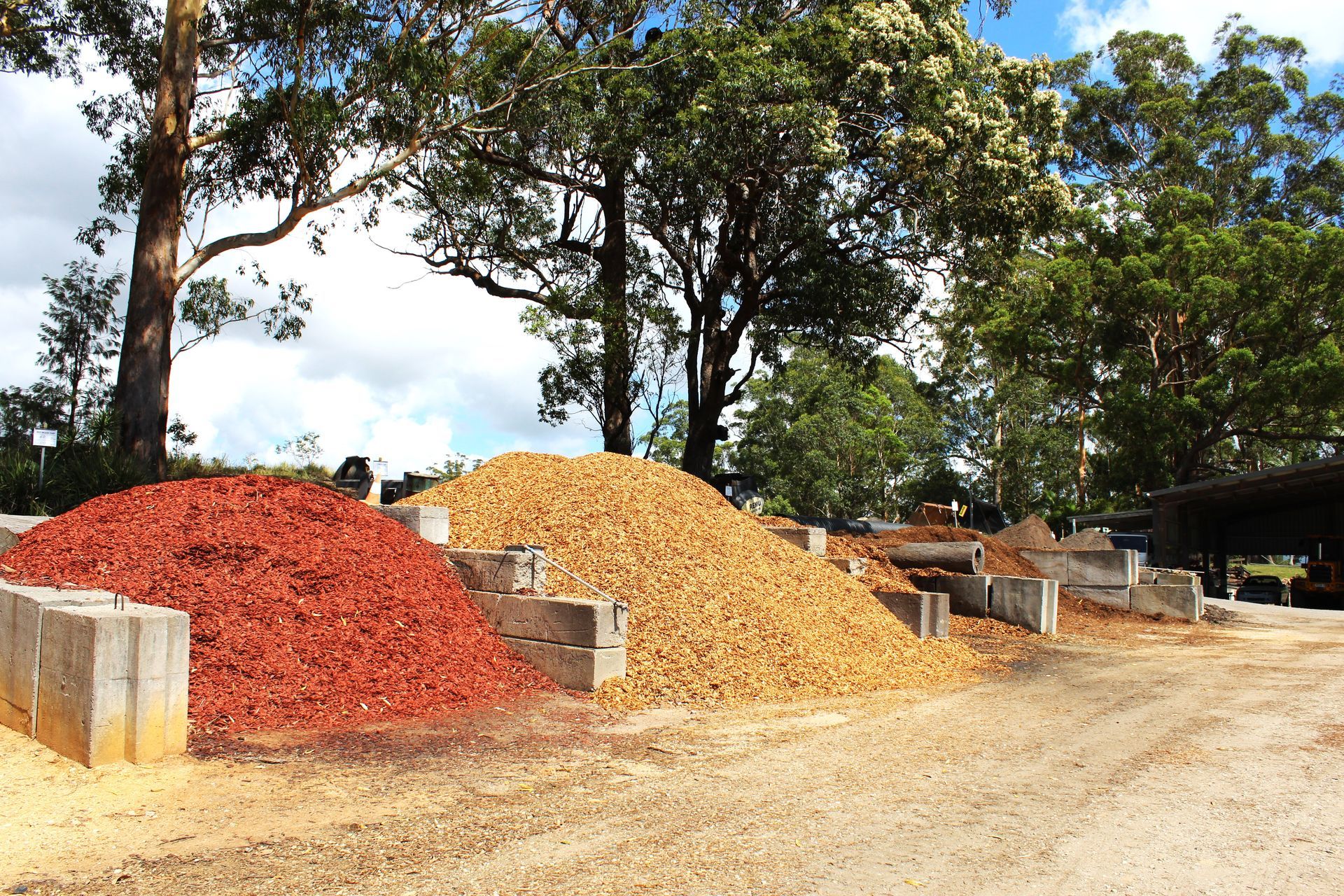 A Pile of Mulch is Sitting in the Middle of a Dirt Field — Blue Dog Landscape Supplies In Bellingen, NSW 