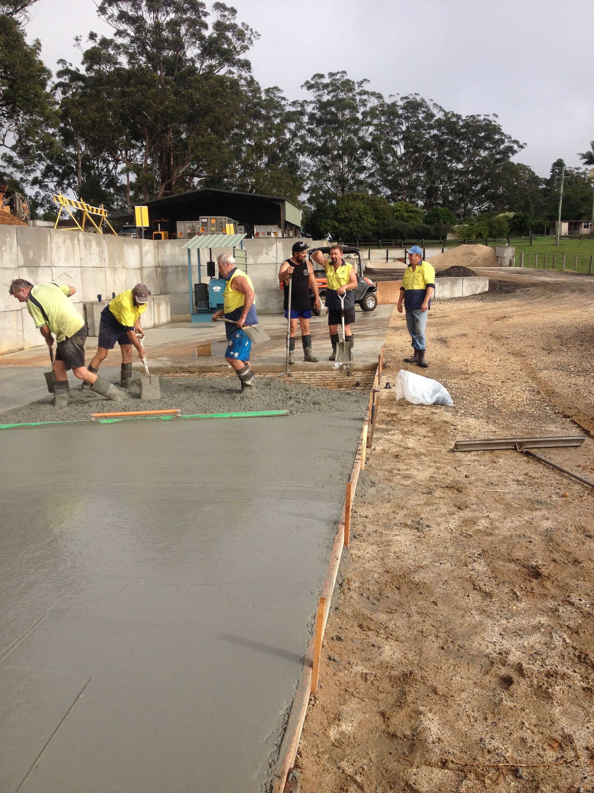 A group of construction workers are working on a concrete surface — Blue Dog Landscape Supplies In Newee Creek, NSW